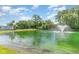 Scenic view of Ocean Creek Plantation's pond with a fountain and lush landscaping under a blue sky at 415 Ocean Creek Dr. # 2372, Myrtle Beach, SC 29572