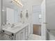 Elegant bathroom featuring double sinks, vanity with storage, and a view to the bedroom at 4196 Ravenwood Dr., Little River, SC 29566