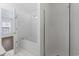 Bright bathroom features a soaking tub, separate shower, and white tile flooring at 4196 Ravenwood Dr., Little River, SC 29566
