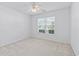 Bedroom with neutral carpeting, a ceiling fan, and a window offering natural light at 4196 Ravenwood Dr., Little River, SC 29566