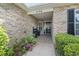 Inviting entrance featuring brickwork, a covered porch, and decorative plantings at 4196 Ravenwood Dr., Little River, SC 29566