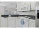 Eat-in kitchen showcasing white cabinets, granite countertops, and appliances at 4196 Ravenwood Dr., Little River, SC 29566