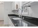 Close-up of kitchen sink and black granite countertops at 4196 Ravenwood Dr., Little River, SC 29566