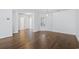 Bright living room boasts hardwood floors, neutral walls, and a window with natural light at 4196 Ravenwood Dr., Little River, SC 29566