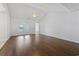 Bright living room featuring hardwood floors, neutral walls, and access to a backyard through glass panel doors at 4196 Ravenwood Dr., Little River, SC 29566