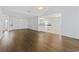 Open-concept living area featuring hardwood floors and transitions seamlessly to the kitchen space at 4196 Ravenwood Dr., Little River, SC 29566