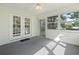 Bright sunroom with ceiling fan, and sliding door to yard at 4196 Ravenwood Dr., Little River, SC 29566