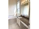 Bathroom featuring a vanity with dual sinks and a soaking tub under a window at 4333 Oakwood Circle, Little River, SC 29566