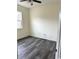 Bright bedroom features gray wood-look floors and a ceiling fan at 4333 Oakwood Circle, Little River, SC 29566