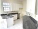 Bright kitchen featuring white cabinets and granite countertops at 4333 Oakwood Circle, Little River, SC 29566