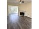 Inviting living room with a cozy fireplace and natural light from large windows at 4333 Oakwood Circle, Little River, SC 29566