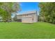 Exterior view of a house with a spacious backyard, green grass, and a beige storage shed at 4600 Murrells Inlet Rd., Murrells Inlet, SC 29576