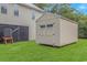 A backyard with green grass that features a beige storage shed at 4600 Murrells Inlet Rd., Murrells Inlet, SC 29576