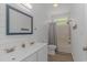 Bright bathroom featuring a double vanity, a bathtub with shower, and shiplap walls at 4600 Murrells Inlet Rd., Murrells Inlet, SC 29576