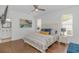 Cozy bedroom featuring a comfortable bed, hardwood floors, and natural light from multiple windows at 4600 Murrells Inlet Rd., Murrells Inlet, SC 29576