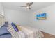 Bright bedroom with a large bed, ceiling fan, and a TV mounted on the wall at 4600 Murrells Inlet Rd., Murrells Inlet, SC 29576