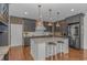 Modern kitchen with gray cabinets, marble countertops, stainless steel appliances, and copper pendant lights at 4600 Murrells Inlet Rd., Murrells Inlet, SC 29576