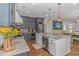 Open kitchen featuring gray cabinets, a large island with seating, and stainless steel appliances at 4600 Murrells Inlet Rd., Murrells Inlet, SC 29576