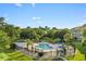 Aerial view of a community pool area with lounge chairs, trees, and a building at 4673 Wild Iris Dr. # 21-201, Myrtle Beach, SC 29577
