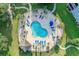Aerial shot of a pool area surrounded by lounge chairs, palm trees, and a fence at 4673 Wild Iris Dr. # 21-201, Myrtle Beach, SC 29577