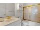 Well-lit bathroom featuring a shower with gold trim and bright white fixtures at 4673 Wild Iris Dr. # 21-201, Myrtle Beach, SC 29577