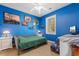 Bright blue bedroom featuring a mounted television and decor at 4673 Wild Iris Dr. # 21-201, Myrtle Beach, SC 29577