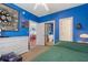 Bright blue bedroom with a ceiling fan, white dresser, and a glimpse into a dining room at 4673 Wild Iris Dr. # 21-201, Myrtle Beach, SC 29577