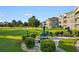 Exterior shot of a well-maintained lawn with a table and chairs, lush green hedges and townhouses at 4673 Wild Iris Dr. # 21-201, Myrtle Beach, SC 29577