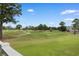 Scenic view of a lush green golf course with trees and a building in the background at 4673 Wild Iris Dr. # 21-201, Myrtle Beach, SC 29577