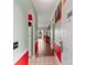 Entryway featuring hardwood flooring, a white refrigerator, and red accent walls at 4673 Wild Iris Dr. # 21-201, Myrtle Beach, SC 29577