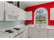 Compact kitchen featuring white appliances, white cabinetry, and white countertops at 4673 Wild Iris Dr. # 21-201, Myrtle Beach, SC 29577