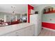 Kitchen view of a living room with red sofa and bar stools at 4673 Wild Iris Dr. # 21-201, Myrtle Beach, SC 29577