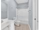 Well-lit bathroom features a vanity, toilet, and shower-tub combo with a white showerhead at 4840 Moss Creek Loop # 38, Murrells Inlet, SC 29576