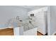 Kitchen features a breakfast bar with granite countertop, white cabinetry and appliances at 4840 Moss Creek Loop # 38, Murrells Inlet, SC 29576