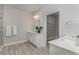 Bright bathroom with double sinks, white cabinets, and a view of the walk in closet at 501 Haven View Way, Murrells Inlet, SC 29576