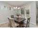 Elegant dining room with modern chandelier and view of covered patio and lake at 501 Haven View Way, Murrells Inlet, SC 29576