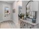 Inviting entryway featuring hardwood floors, decorative mirror, and stylish accent furniture at 501 Haven View Way, Murrells Inlet, SC 29576