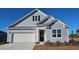Charming home featuring light-blue siding, a garage, and a black front door at 501 Haven View Way, Murrells Inlet, SC 29576
