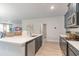 Well-equipped kitchen with stainless steel appliances, gray cabinets, and eat-in island at 501 Haven View Way, Murrells Inlet, SC 29576