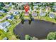 Aerial view of home showcasing proximity to the pond, neighboring residences, and well maintained landscaping at 5031 Medieval Dr., Conway, SC 29526
