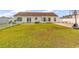 Spacious back yard with manicured lawn, patio, and basketball hoop; perfect for Gathering fun and relaxation at 5031 Medieval Dr., Conway, SC 29526