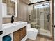 Beautiful bathroom featuring modern vanity, wood-look tile, and glass enclosed shower with built in seat at 5031 Medieval Dr., Conway, SC 29526