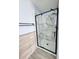 Modern bathroom featuring a glass-enclosed shower with marble tiling and black fixtures at 5031 Medieval Dr., Conway, SC 29526