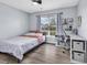 Cozy bedroom featuring a ceiling fan, a large window, and a corner desk perfect for a home office at 5031 Medieval Dr., Conway, SC 29526