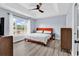 Bedroom with tray ceiling, large window with natural light, and wood-look flooring at 5031 Medieval Dr., Conway, SC 29526