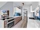 Sleek kitchen featuring a cooktop, wood cabinets, white countertops, and a stylish blue backsplash at 5031 Medieval Dr., Conway, SC 29526