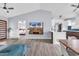 Open-concept living area with hardwood floors, modern fixtures, and a view into the kitchen and bedroom at 5031 Medieval Dr., Conway, SC 29526