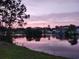 Peaceful pond view featuring a lovely sunset, still water reflection, and nearby residences at 5031 Medieval Dr., Conway, SC 29526