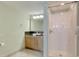 Bathroom with a tiled floor, wooden cabinets, and a shower with curtain at 504 N Ocean Blvd. # 1106, Myrtle Beach, SC 29577