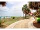 Scenic walkway leading to a sandy beach with palm trees and an ocean view at 504 N Ocean Blvd. # 1106, Myrtle Beach, SC 29577